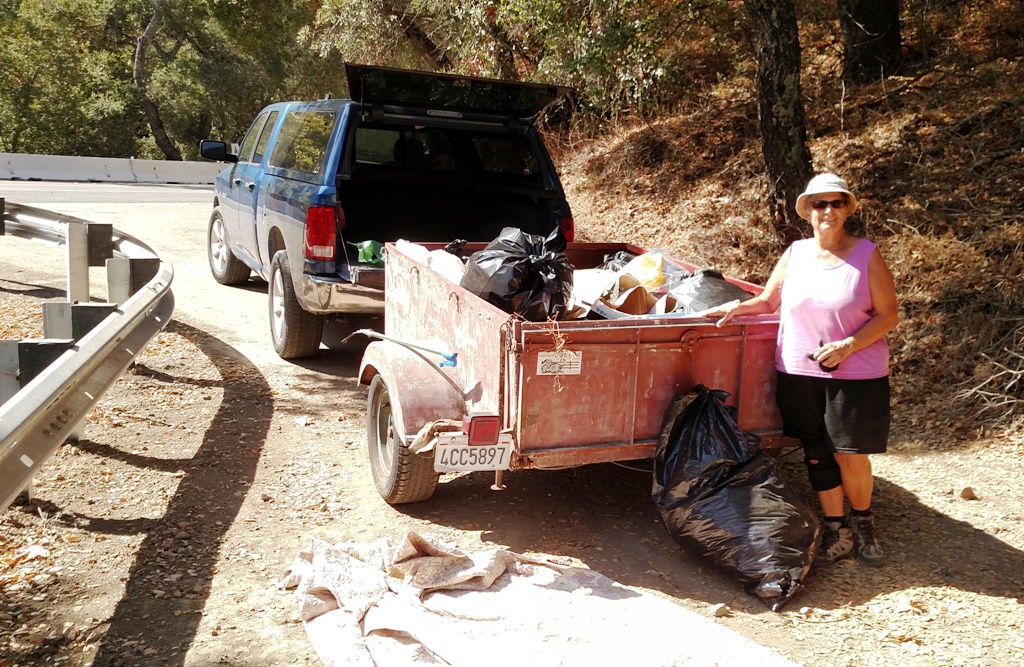 ALPS Volunteer Kathy Bantz loading trash into the trailer!